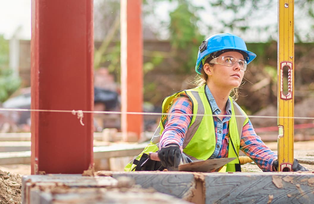 Female labourer measuring on construction site