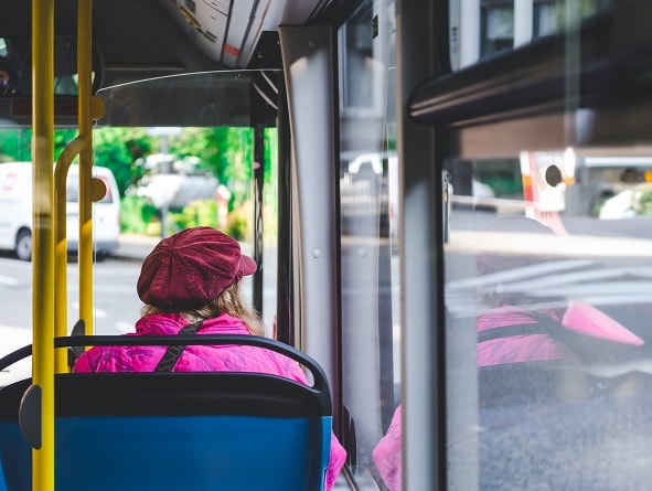 Lady on bus looking outside window